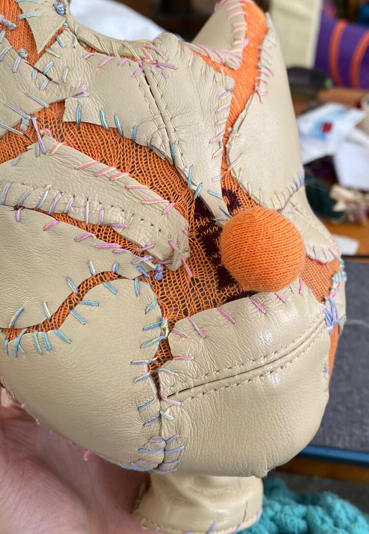 Detail of Cloe, 2023 (leather, thread, sock, 3D printed doll head)